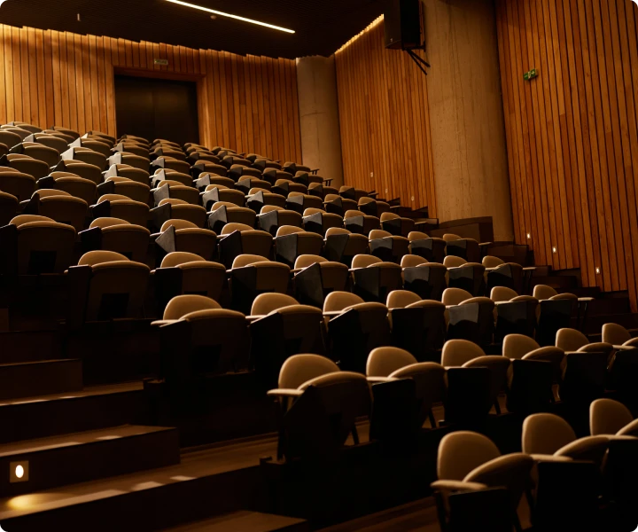 Auditorium with dim lighting and empty chairs