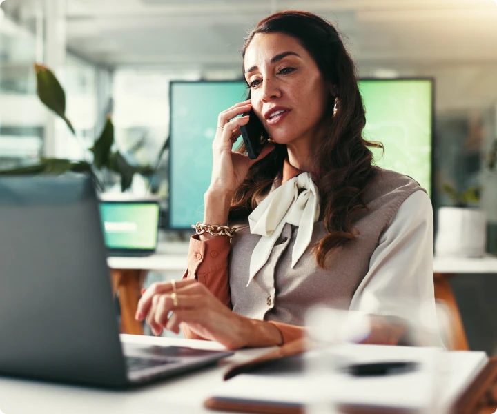 Woman talking on phone in office